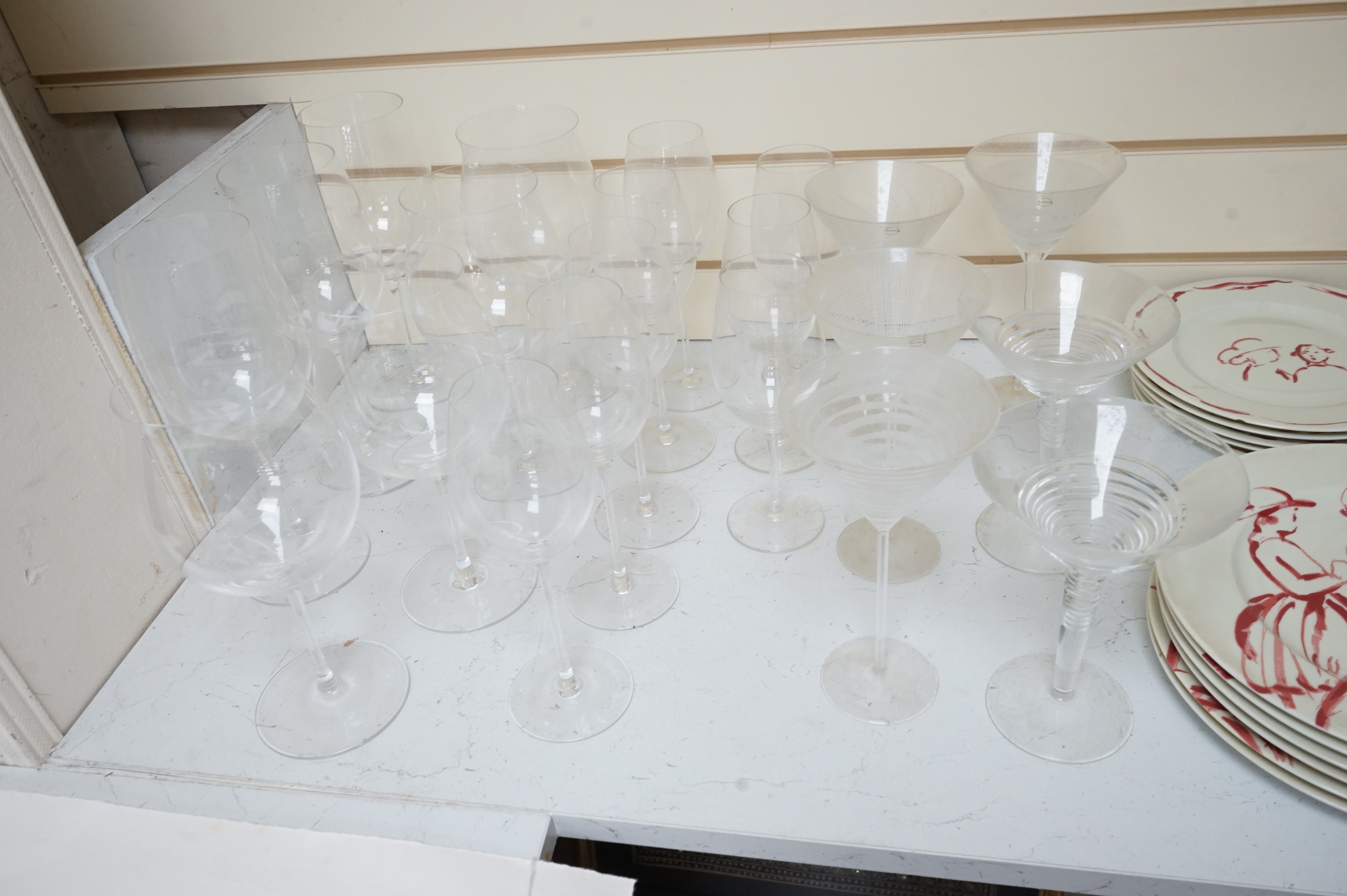 A Pierre Frey ‘Gonesse’ Limoges part dinner service, two Villeroy and Boch ‘Jardins Francais’ dinner plates, with a collection of Riedel wine glasses and mixed Salviati champagne glasses. Villeroy and Boch plates 30.5cm